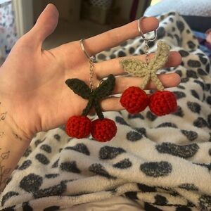 Crochet cherry keychains in pink or red and or dark or light green leaves